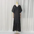 Full-length view of a elegant black V-neck maxi dress with 3D floral details on a mannequin. - M / Dresses / Black