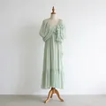 Detailed view of light green V-neck dress with 3D floral applique on a mannequin - M / Dresses / Green