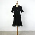 Detailed view of a black French style knit two-piece set displayed on a mannequin. - Black