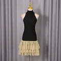 Detail of sleeveless bodycon dress with champagne tiered ruffle hem and high neck. - S / Dresses / Black Patchwork Champagne