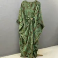 Loose casual printed maxi dress with V-neck and decorative gold metal flower buckle - One Size / Dresses / Green