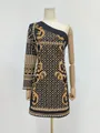 Detailed macro view of a black retro dress featuring gold prints and pearls - S / Dresses / Yellow