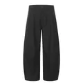 Detail view of black curved-leg pleated trousers in a relaxed Cleanfit aesthetic. - S / Bottoms / Black