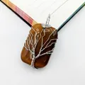 Macro view of handmade wire-wrapped tree of life pendant with brown tiger eye stone - Tiger's Eye Pendant / 1 Piece / Tiger's Eye