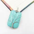 Detailed view of wire-wrapped turquoise stone pendant featuring silver Tree of Life design - Turquoise