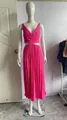 Detailed view of a hot pink V-neck sleeveless pleated dress featuring stylish waist cut-outs - Fuschia