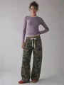 Full-length view of stylish women's loose camouflage cargo pants featuring drawstring waist - S / Bottoms / Camouflage