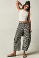 Full body shot showing the loose barrel fit and leopard print detail of the jeans - White Leopard