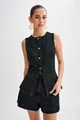 Detailed view of a dark denim sleeveless vest and high-waisted shorts set on a model - S / Top And Bottom / Dark Blue