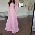 Elegant pink long-sleeved maxi dress featuring a ruffled waist and flared sleeve design. - XS / Dresses / Pink