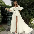 Elegant white off-the-shoulder wedding dress with bubble sleeves and a high leg slit. - US16 / Dresses / Ivory