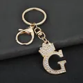Close-up of the sparkling rhinestone initial G keychain with golden crown detail - Letter G Decoration (YJ—310) / Gold