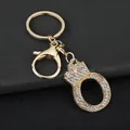Detail showing a gold-tone letter O keychain with rhinestones and a crown charm - Letter O Decoration (YJ—310) / Gold