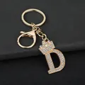Close-up of a premium gold-tone sparkly letter D keychain with rhinestone crown - Letter D Decoration (YJ—310) / Gold