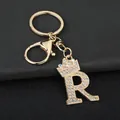 Close-up detail of a gold-toned letter R keychain encrusted with sparkling crystals. - Letter R Decoration (YJ—310) / Gold