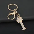 Close-up of golden letter I keychain with sparkling rhinestones and crown detail. - Letter I Decoration (YJ—310) / Gold