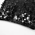 Macro detail view of the dense black sequin texture and shimmering light-reflecting surface - S / Black