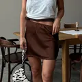 Elegant brown satin mini skirt featuring delicate lace trim and elastic waistband - S / Brown