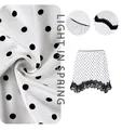 Detailed macro of white polka dot skirt with intricate black lace hem and satin finish - S / White