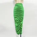 Detailed view of a vibrant green ruched knit skirt with sparkling rhinestones. - S / Bottoms / Green Long Dress