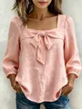 Detail of pink square neck blouse featuring a large decorative bow tie at the chest - S / Tops / Pink