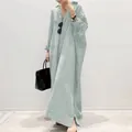 Full-length view of a green and white striped oversized maxi shirt dress on a model - Light Green
