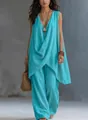 Woman wearing sleeveless turquoise cotton linen resort set with wide-leg pants and straw bag - Lake Blue