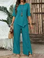 Detail of elegant teal two-piece set with asymmetrical hem and buttoned wide-leg pants - S / Top And Bottom / Teal