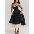 Detail of a flared black midi dress featuring a visible cream-colored tulle petticoat - S / Black