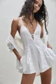 Fashionable white sleeveless denim romper with a deep V-neck and pleated shorts detail. - White