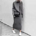 Detail of grey knitted two-piece set featuring turtleneck sweater and long skirt. - S / Top And Bottom / Gray