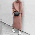 Model wearing a stylish two-piece knit set with turtleneck sweater and long skirt - S / Top And Bottom / Pink
