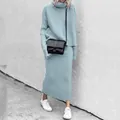 Close-up of light blue knitted turtleneck sweater and maxi skirt set worn by a model - S / Top And Bottom / Blue