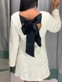 Detail of white sequined dress featuring a large black satin bow on the back. - XS / Dresses / White