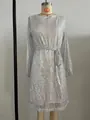 Close-up of silver sequin party dress on mannequin featuring elegant waist tie detail - 2XL / Dresses / White Silver