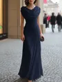 Detail view of a navy blue floor-length dress with elegant cowl neck and ruched waistline. - Navy Blue