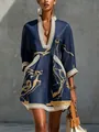 Close-up of navy blue dress featuring gold abstract prints and delicate lace trim - S / Dresses / Blue