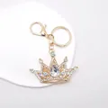 Detail of golden crystal crown keychain with sparkling rhinestones and lobster clasp - White