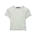 Detailed view of the elegant texture on a light green retro flocked lace short-sleeve T-shirt - XS / Tops / Light Green