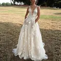 Elegant white lace wedding dress with a deep V-neck and exquisite floral embroidery - S / Dresses / Ivory