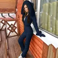 One-piece dark blue hooded ski suit with fur trim and matching gloves outdoors. - Dark Blue