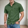 Close-up shot of a men's casual green short-sleeved denim shirt with lapel and chest pocket - Army Green