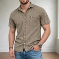 Detailed view of a men's vintage washed brown denim shirt with a chest pocket and lapel collar. - S / Tops / Khaki
