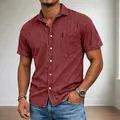 Close-up detail of men's burgundy short sleeve denim shirt featuring a chest pocket and lapel - S / Tops / Red