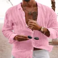 Detail view of a pink long-sleeved men's linen beach shirt featuring button-down design. - Pink