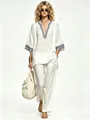 Elegant woman wearing a bohemian ivory linen V-neck printed top and matching pants - S / Top And Bottom / White