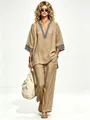 Detailed view of bohemian linen two-piece set with ethnic embroidery on a model - S / Top And Bottom / Khaki