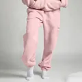 Detailed view of pink unisex loose sweatpants with elasticated cuffs for casual wear. - S / Bottoms / Light Pink