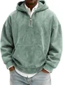 Macro detail of men's sage green suede half-zip hoodie featuring front kangaroo pocket - Green
