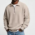 Close-up detail of a men's retro waffle knit half-zip polo shirt in a stylish khaki beige color - Khaki